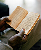 ERITREA, Asmara, the hands of Abdullah Omar holding the Koran at the Asmara Post Office