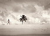 FIJI, young woman in bikini running on beach, Northern Lau Islands (B&W)