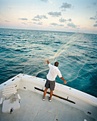 USA, Florida, fisherman on the Fish Tales casting a net, elevated view, Islamorada