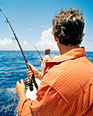 USA, Florida, men fishing on boat in the Atlantic, Islamorada