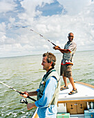USA, Florida, two men fishing on on a small boat, Ivory Keys