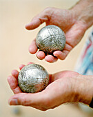 FRANCE, human hands holding pentaque balls, Saint-Paul de Vence