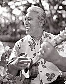 USA, Hawaii, smiling senior man playing ukulele, Four Seasons, The Big Island
