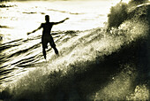 USA, Hawaii, silhouette of a man surfing, The North Shore, Oahu