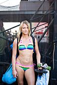 USA, Hawaii, Oahu, portrait of a beautiful young woman in bikini holding skateboard, Waimea Bay