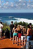 USA, Hawaii, Maui, spectators watch windsurfers on large waves at a break called Jaws or Peahi