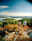 USA, Idaho, man and woman hiking on a mountain above Priest Lake