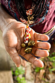 INDONESIA, Mentawai Islands, Kandui Resort, close-up of woman holding rosary