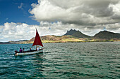 MAURITIUS, Trou D'eau Deuce, sailors on the East coast of Mauritius with the 4 Sisters Mountains in the background, Indian Ocean