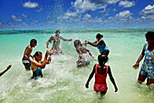 MAURITIUS, a family plays and enjoys a hot day at the beach, Ile aux Cerfs Island, the Indian Ocean