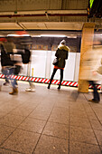 USA, New York, a woman standing waiting for the subway, New York City