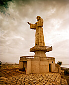 NICARAGUA, San Juan Del Sur, a statue of Jesus sits atop a hill looking over the bay and town