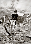 REPUBLIC OF GEORGIA, boy playing with a toy made out of an old bike rim (B&W)