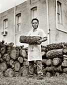 USA, Texas, portrait of chef holding firewood, Kreuz Market Barbeque (B&W)