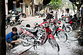 VIETNAM, Hanoi, boys wash, detail and clean mopeds
