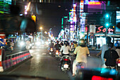 VIETNAM, Saigon, Ho Chi Minh City, mopeds speed through the city at night