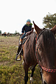 USA, Wyoming, Encampment, a young boy sits on a horse for the first time, Abara Ranch