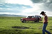 USA, Wyoming, Encampment, ranch hands move towards a corral to begin branding calves, Big Creek Ranch