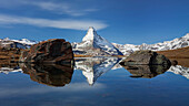View of the Matterhorn and its reflection in Lake Stelli in autumn, Zermatt, Valais, Switzerland