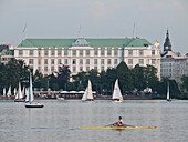 View over the Lake Alster with rowing boats and sailing boats in front of the Atlantic hotel, Hanseatic City of Hamburg, Germany