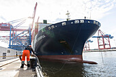 Worker fixed the mooring line of CMA CGM Cassiopeia in Hamburg, Burchardkai, Hamburg, Germany