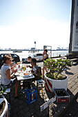 Staff of Elbstern advertising agency during friday lunch on the company car park, near Altona fish market, Hamburg Harbour, Germany