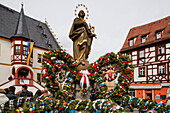 Easter egg decorations at the fountain on the market square, Volkach, Lower Franconia, Bavaria, Germany