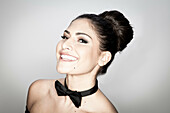 Smiling woman wearing bow tie