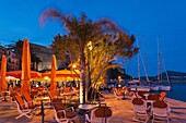 France, Corsica, Haute-Corse Department, La Balagne Region, Calvi, Port de Plaissance, yacht harbor, waterfront cafe, dusk