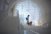 Woman and Son in Sled in Doorway of Ice Hotel, Quebec City, Quebec
