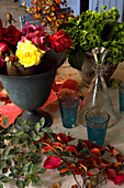 cut flowers in various vases on a table