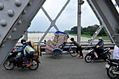 Vietnamese crosses the Trang Tien Bridge at the Perfume River in Hue, Central Vietnam, Vietnam, South East Asia, Asia