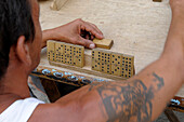 Cuba man playing dominoes in Cienfuegos, Cuba