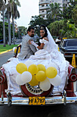 Bride and groom in a vintage car in Havana, Cuba