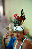 Man with colorful chicken on head