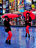 Two womens with red umbrella in Times Square, New York City, New York State, United State, USA