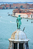 View on Venice from San Giorgio Maggiore island, focus on statue, Italy, Europe