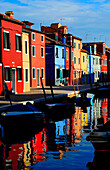 Colorful houses beside Burano's Grand Canal in the island of Burano near Venice, Italy, Europe