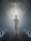 CHILD RUNNING IN MIST TO LIGHT AT END OF TUNNEL
