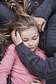 Young blonde girl lying in her mother's lap, hartford connecticut usa