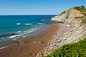 People Sunbathing At Itzurun Beach, Zumaia, Basque Country, Spain