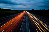 Car Trails On The Freeway At Night In Wiltshire, Uk