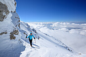 Female backcountry skier ascending to Monte Amaro, Rava della Vespa, Maiella, Abruzzo, Italy