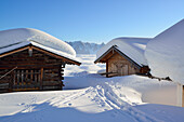 Snow-covered alpine huts with Tennengebirge range in the background, near Arthurhaus, Hochkoenig, Berchtesgaden range, Salzburg, Austria