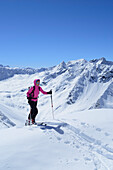 Female backcountry skier ascending to Gleirscher Rosskogel, Pforzheim Hut, Sellrain, Stubai Alps, Tyrol, Austria