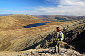 Female hiker looking to Half Way Loch, Ben Nevis, Highlands, Scotland, United Kingdom