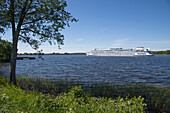 River cruise ship passing Kizhi Pogost, Kizhi Island, Lake Onega, Russia, Europe