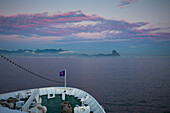 Bow of cruise ship MS Deutschland (Reederei Peter Deilmann) approaching Rio at dawn, with Pao de Acucar (Sugar Loaf) mountain in the background, Rio de Janeiro, Rio de Janeiro, Brazil