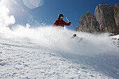 Man downhill skiing in deep snow, Marmolata, Trentino, Italy