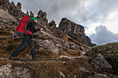 Young man hiking, Sexten Dolomites, Belluno, Veneto, Italy